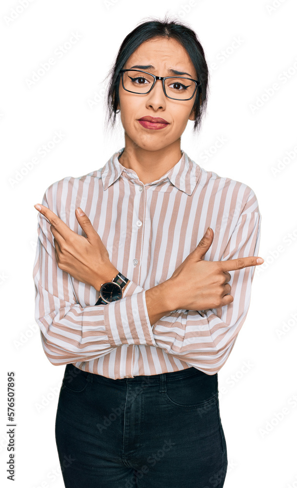 Young hispanic girl wearing casual clothes and glasses pointing to both sides with fingers, different direction disagree Young hispanic girl wearing casual clothes and glasses pointing to both sides with fingers, different direction disagree