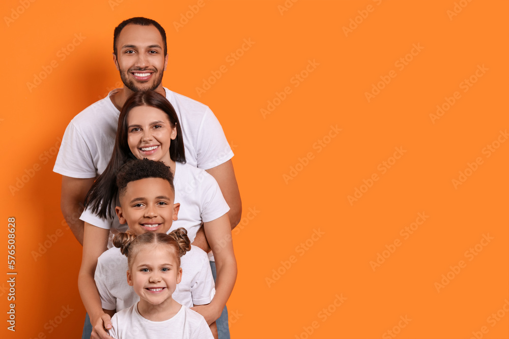 Happy international family with children on orange background. Space for text Happy international family with children on orange background. Space for text
