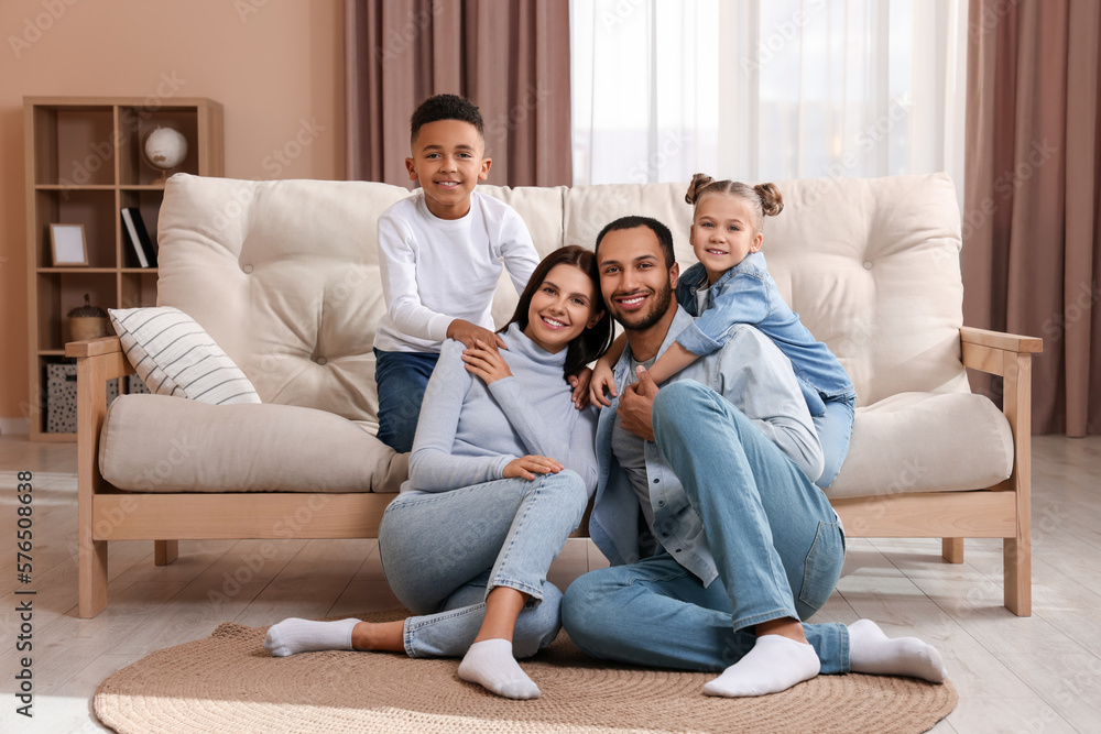 Happy international family with children near sofa at home
