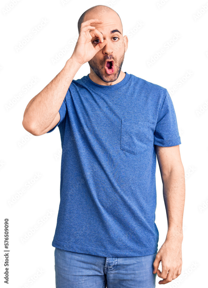 Young handsome man wearing casual t shirt doing ok gesture shocked with surprised face, eye looking through fingers. unbelieving expression. Young handsome man wearing casual t shirt doing ok gesture shocked with surprised face, eye looking through fingers. unbelieving expression.