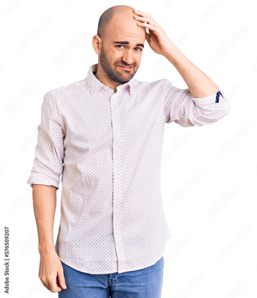 Fototapeta premium Young handsome man wearing elegant shirt confuse and wonder about question. uncertain with doubt, thinking with hand on head. pensive concept.
