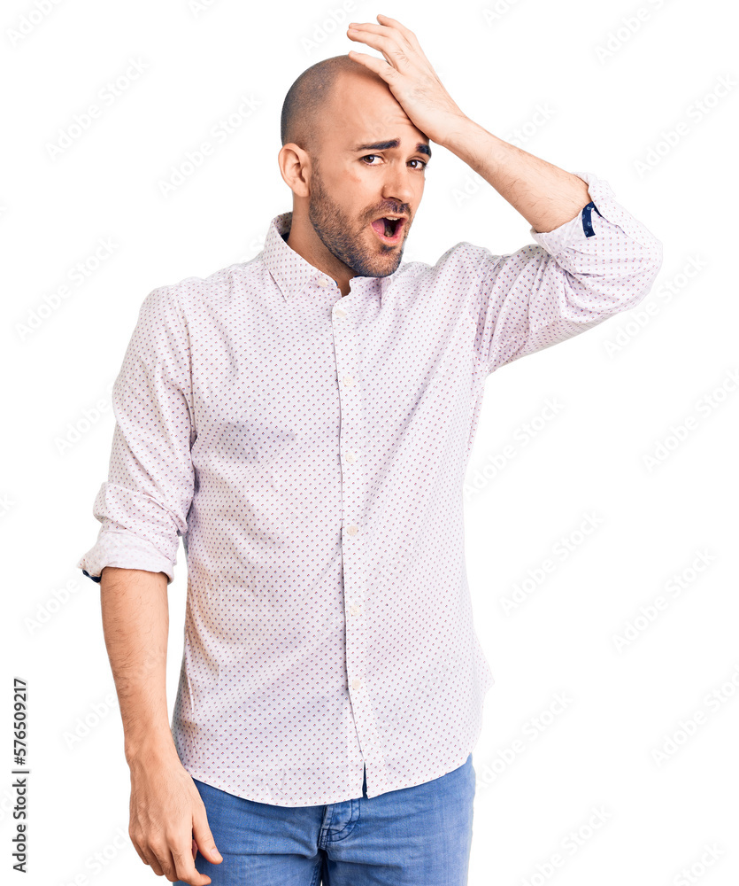 Young handsome man wearing elegant shirt surprised with hand on head for mistake, remember error. forgot, bad memory concept. Young handsome man wearing elegant shirt surprised with hand on head for mistake, remember error. forgot, bad memory concept.