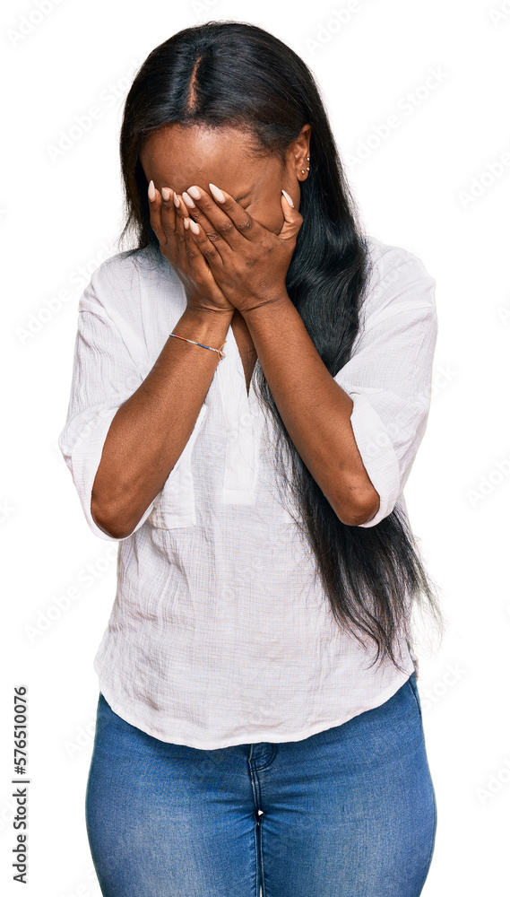 Young black woman wearing casual clothes with sad expression covering face with hands while crying. depression concept. Young black woman wearing casual clothes with sad expression covering face with hands while crying. depression concept.