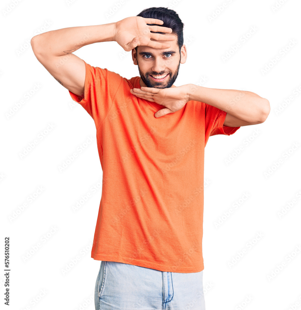 Young handsome man with beard wearing casual t-shirt smiling cheerful playing peek a boo with hands showing face. surprised and exited Young handsome man with beard wearing casual t-shirt smiling cheerful playing peek a boo with hands showing face. surprised and exited