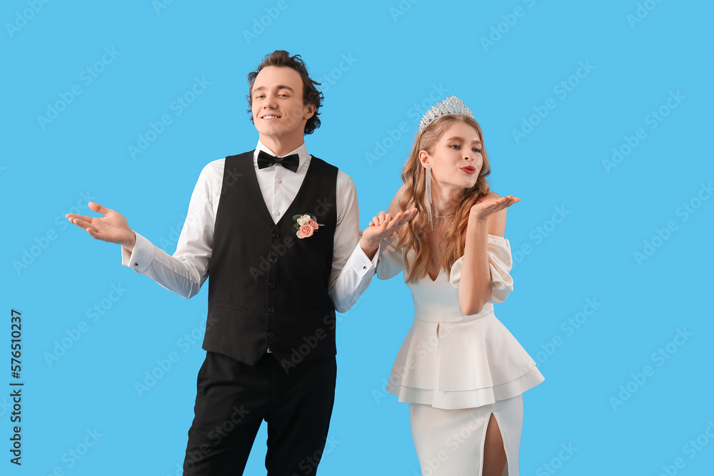 Beautiful couple dressed for prom on blue background Stock Photo
