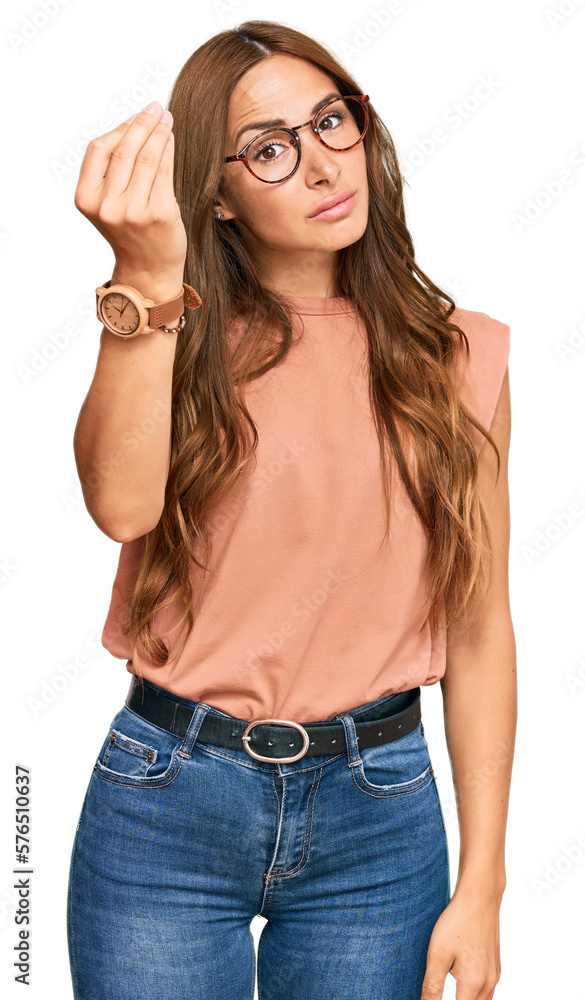 Young hispanic woman wearing casual clothes and glasses doing italian gesture with hand and fingers confident expression Young hispanic woman wearing casual clothes and glasses doing italian gesture with hand and fingers confident expression