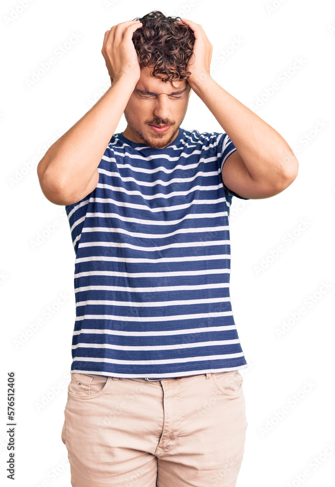 Young handsome man with curly hair wearing casual clothes suffering from headache desperate and stressed because pain and migraine. hands on head. Young handsome man with curly hair wearing casual clothes suffering from headache desperate and stressed because pain and migraine. hands on head.