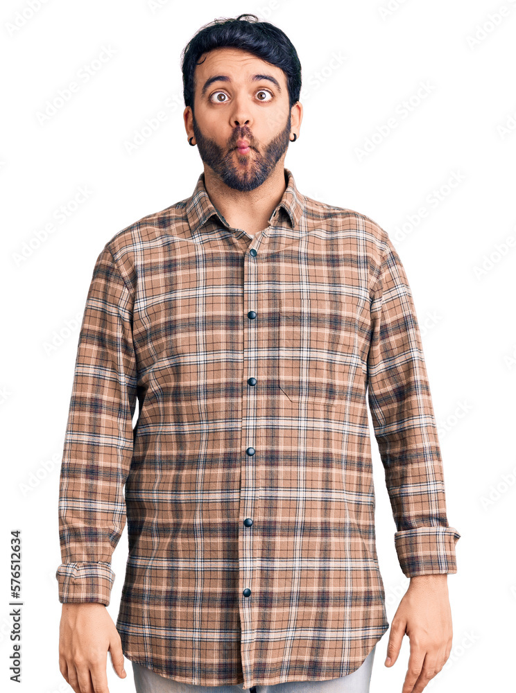 Young hispanic man wearing casual clothes making fish face with lips, crazy and comical gesture. funny expression. Young hispanic man wearing casual clothes making fish face with lips, crazy and comical gesture. funny expression.
