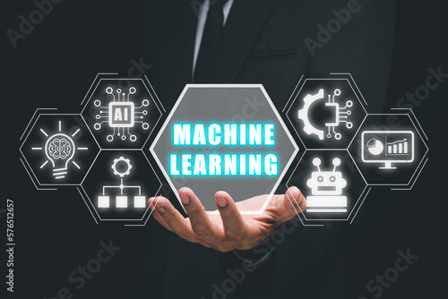 Machine learning concept, Businessman hand holding machine learning icon on virtual screen.