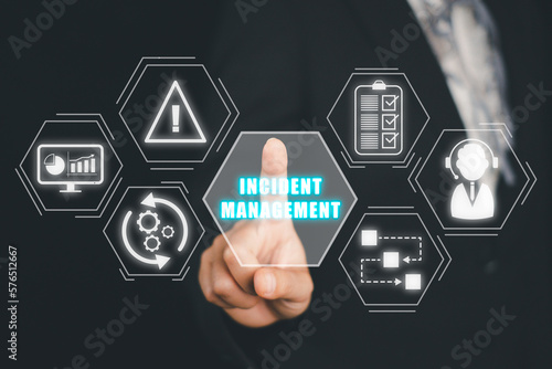 Incident Management process Business Technology concept, Business person hand touching incident management icon on virtual screen. photo