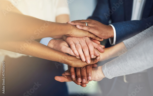 Work together  win together. Cropped shot of a team of colleagues joining their hands together in unity.