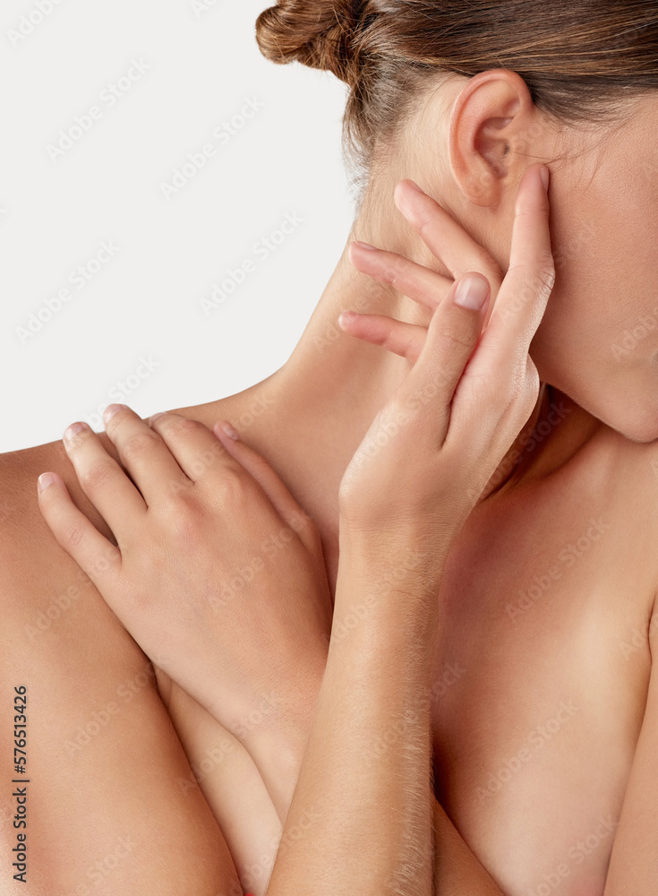 Fototapeta premium Reveling in her softness. Closeup studio shot of a beautiful young woman caressing her skin.