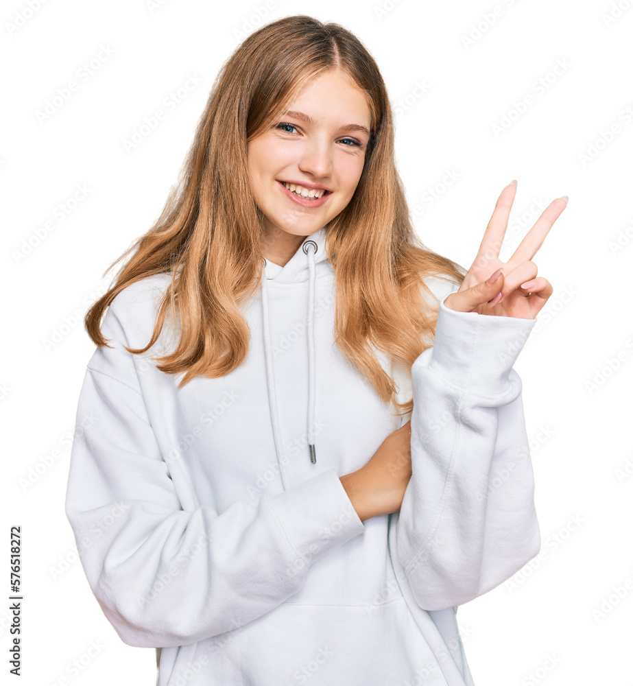 Beautiful young caucasian girl wearing casual sweatshirt smiling with happy face winking at the camera doing victory sign. number two. Beautiful young caucasian girl wearing casual sweatshirt smiling with happy face winking at the camera doing victory sign. number two.