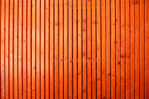 Orange colored wooden surface. Wooden fence material. vivid color wooden wall. 