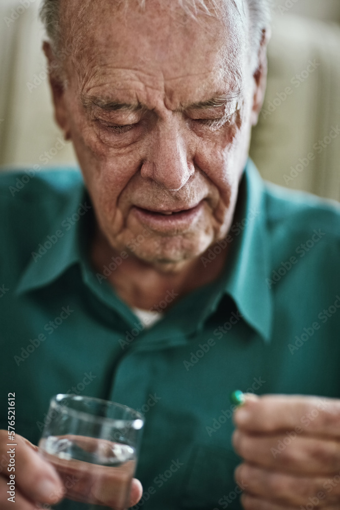 Managing his chronic condition to stay healthy. Cropped shot of a senior man about to take his medication. Managing his chronic condition to stay healthy. Cropped shot of a senior man about to take his medication.