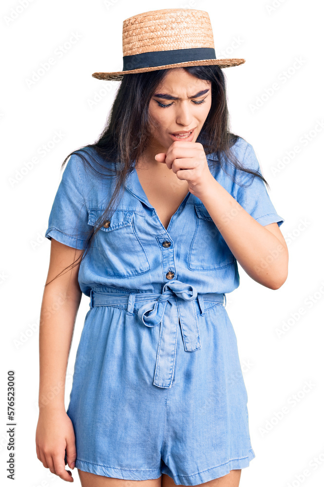 Brunette teenager girl wearing summer hat feeling unwell and coughing as symptom for cold or bronchitis. health care concept. Brunette teenager girl wearing summer hat feeling unwell and coughing as symptom for cold or bronchitis. health care concept.