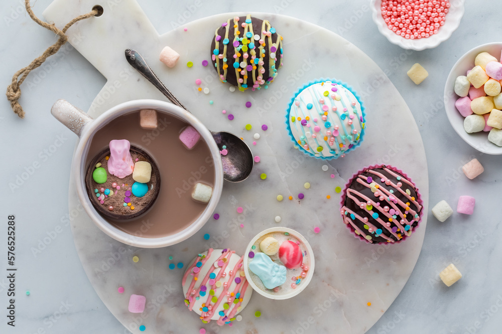 A mug filled with hot chocolate served with Easter hot cocoa bombs.