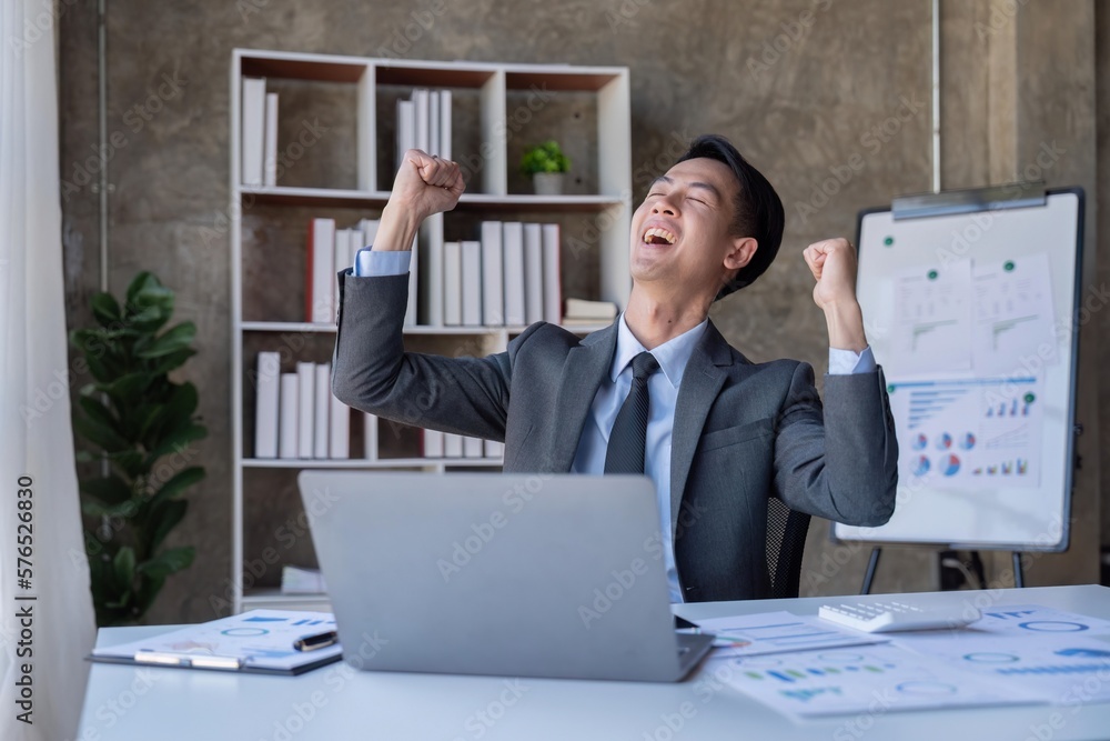 Naklejka premium Marketing, Financial, Accounting, and Planning, a businessman expresses his joy at making annual profits for a successful company