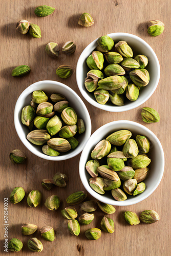 Wallpaper Mural Pistachio nuts in a bowl on a tabletop with bright, warm colors. Healthy, snack, food concept created with generative AI. Torontodigital.ca