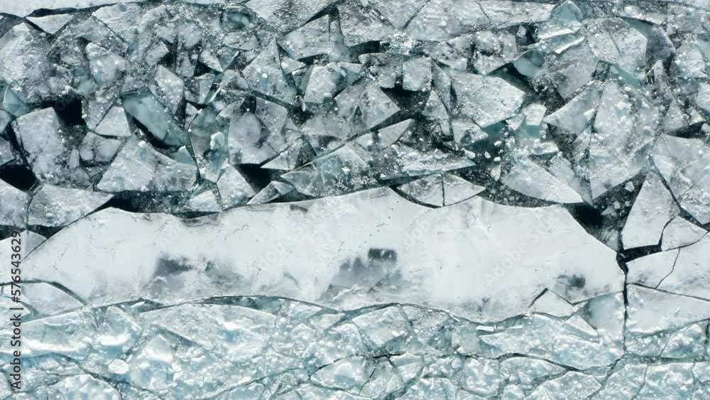 Aerial top down, cracked thin ice sheet caused by global warming. Concept of climate change and social issues Aerial top down, cracked thin ice sheet caused by global warming. Concept of climate change and social issues