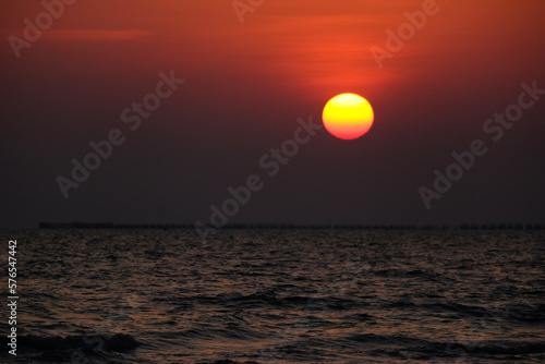 Background Sunset sky in the evening with orange-yellow over tropical sea coast paradise island sea nature