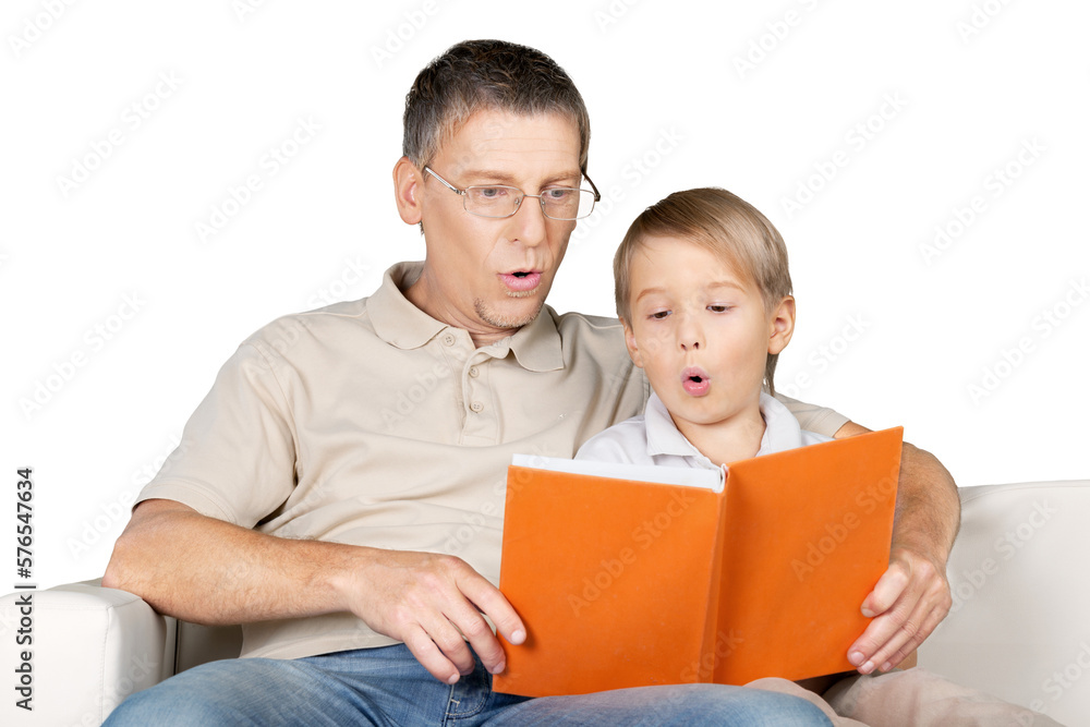 Father and Son Reading a Book on the Couch Father and Son Reading a Book on the Couch