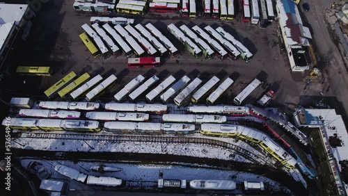 Aerial view of public transportations parking lot with buses and trams covered with snow photo