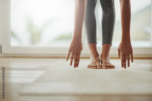 Yoga can always be modified to fit peoples needs. Cropped shot of a young woman practicing yoga at home. © Donson/peopleimages.com