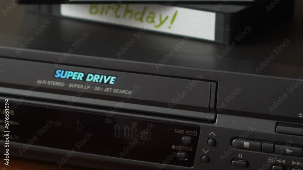 home video archive with a record of a birthday and a wedding on video cassettes. watching a wedding on a video player. a family video library home video archive with a record of a birthday and a wedding on video cassettes. watching a wedding on a video player. a family video library