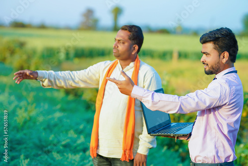 indian farmer and banker showing some detail in farm