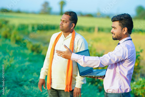 indian farmer and banker showing some detail in farm