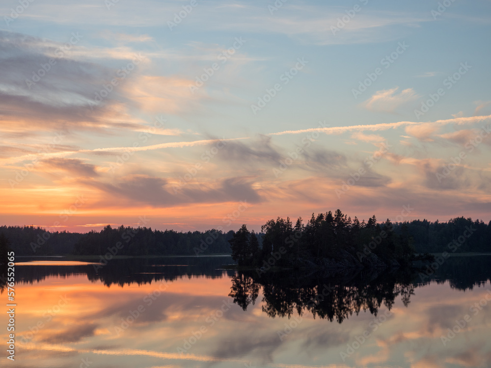 sunset over a forest lake in summer