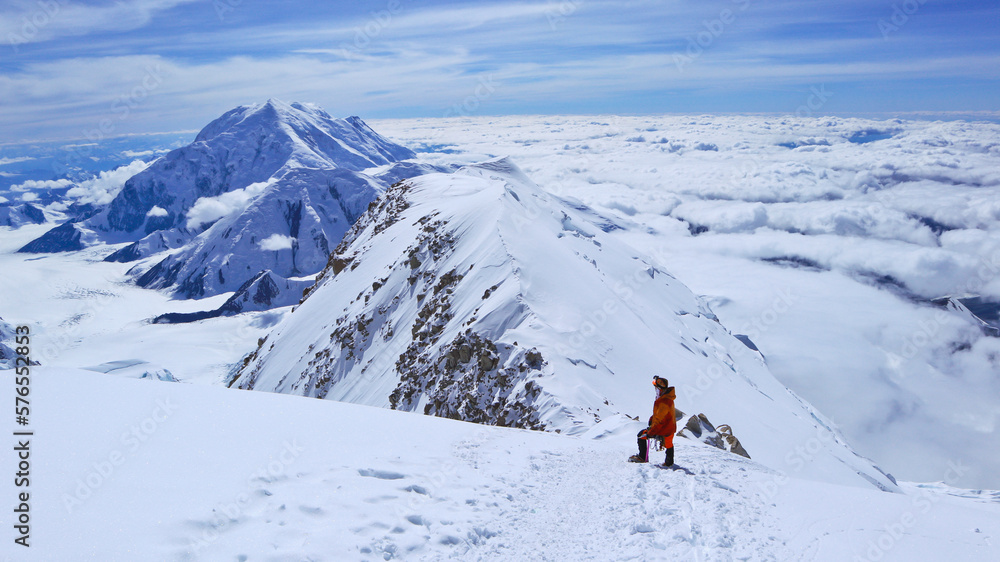 A climber enjoying panoramic view on Mt Denali in Alaska, the highest mountain in North America A climber enjoying panoramic view on Mt Denali in Alaska, the highest mountain in North America