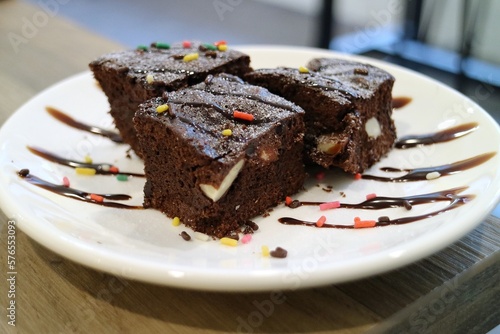 Three dark chocolate brick cakes on a plate