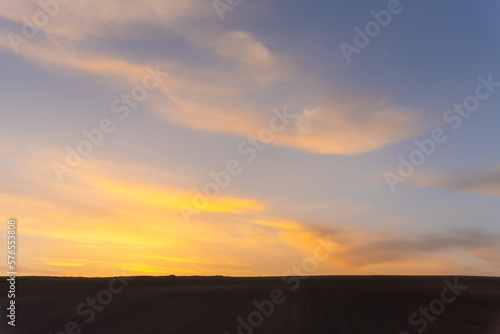 Farmland, a hill with blue sky background in dusk. Silhouette view nature landscape.