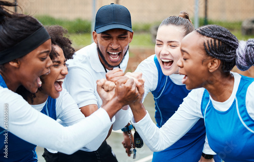 Fist, motivation or team support in netball training game screaming with hope or faith on sports court. Teamwork, fitness coach or group of excited athlete girls with pride or solidarity together