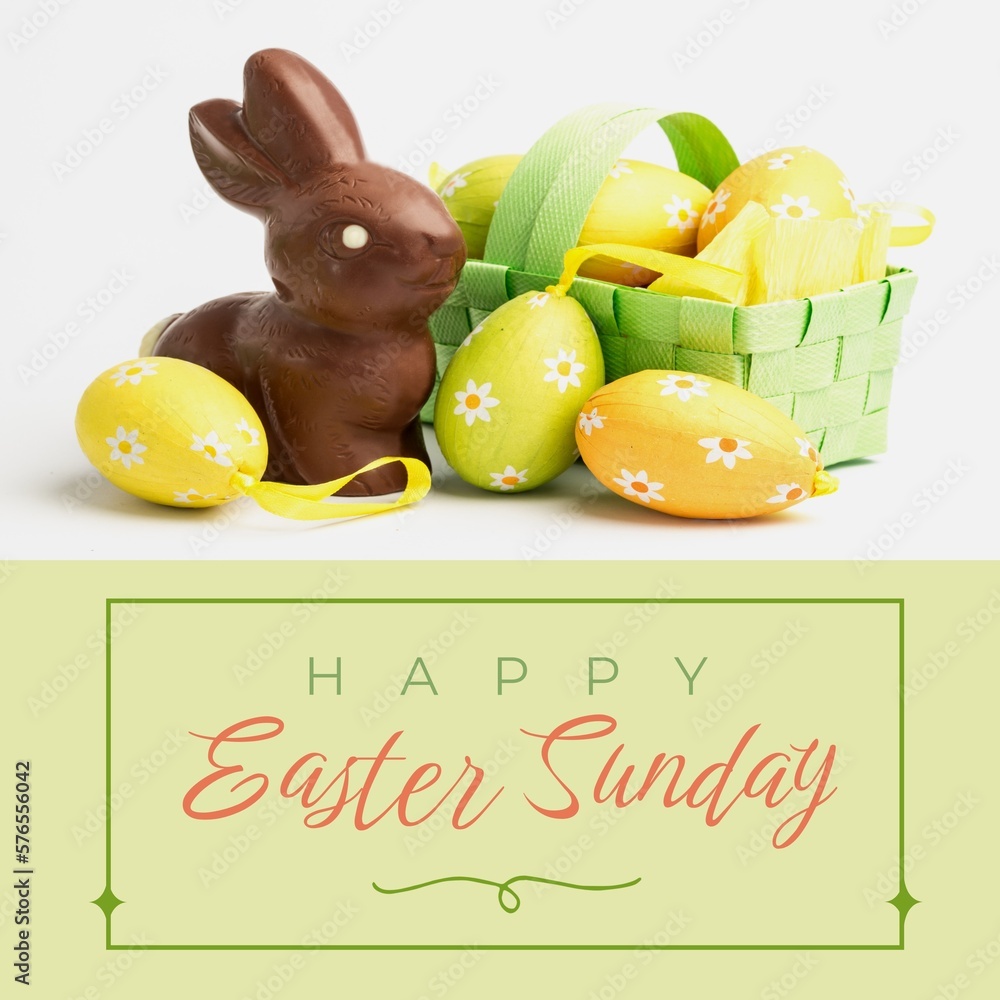 Naklejka premium Image of happy easter sunday text over chocolate rabbit and easter eggs