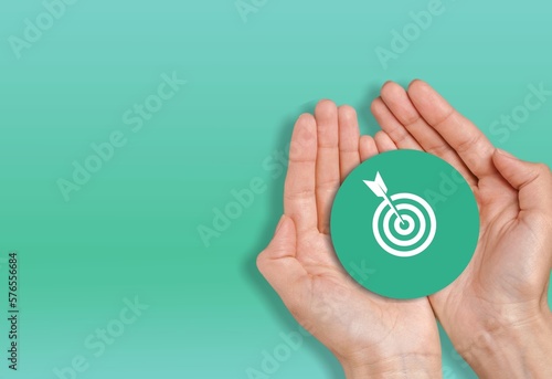 Hand holding sign with target, business plan concept