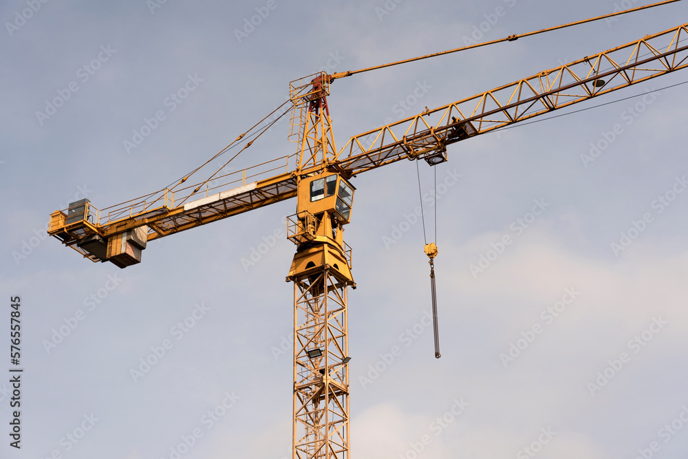 Crane and construction site against the blue sky. Working on large construction sites, and many cranes working in the new construction business. Crane and construction site against the blue sky. Working on large construction sites, and many cranes working in the new construction business.