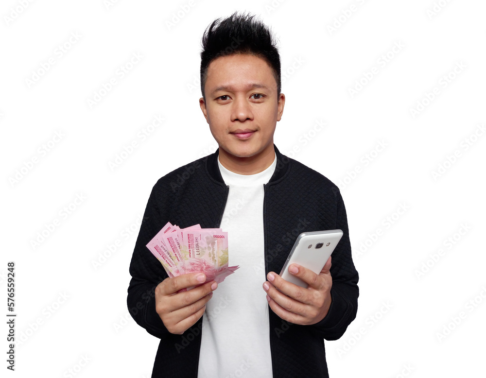 Man holding smartphone and holding Indonesian money smiling looking at camera Man holding smartphone and holding Indonesian money smiling looking at camera