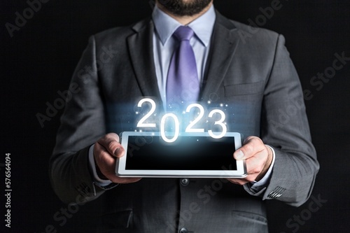 Businessman holding 2023 number, new year