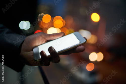 Business info whenever he needs it. Cropped shot of a businessman using a digital tablet at night. photo