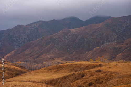 Amazingly beautiful autumn landscapes of a mountainous area located in northern China. Rainy landscape with clouds on top of mountains. Beautiful non-tourist routes. Exploring new places.