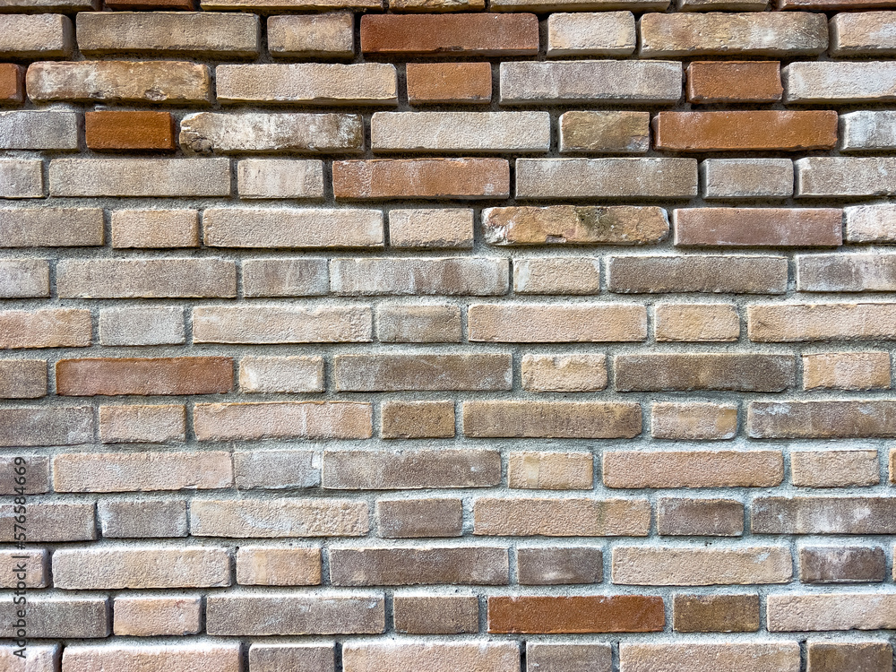 Fototapeta premium Modern brick textured wall background in design loft style. Grunge reddish brown colored with copy space. Blank poster or wallpaper surface template. Partly damaged pattern.