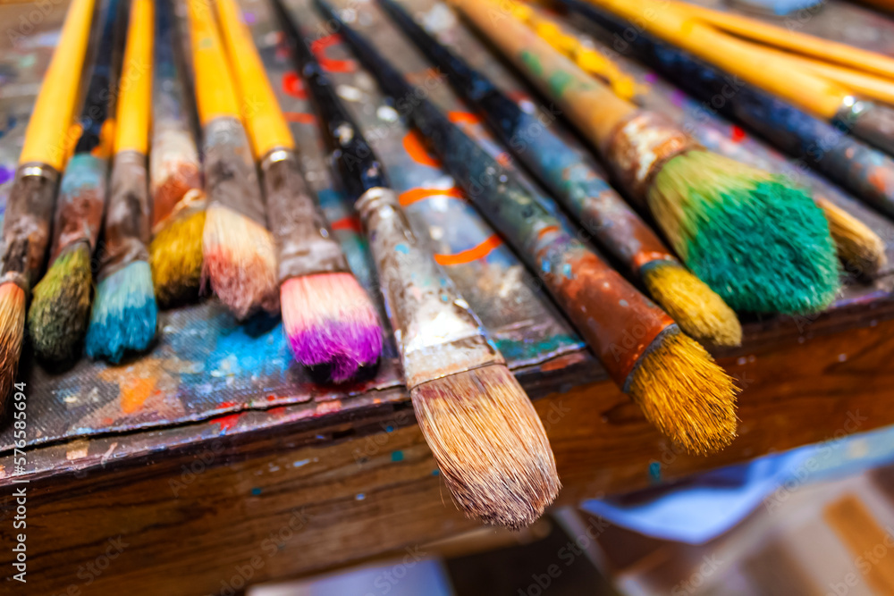 Fototapeta premium Paint brushes on palette paper