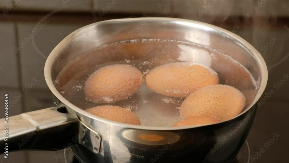 Brown eggs cooking in saucepan on the electric stove close-up. Brown eggs cooking in saucepan on the electric stove close-up.