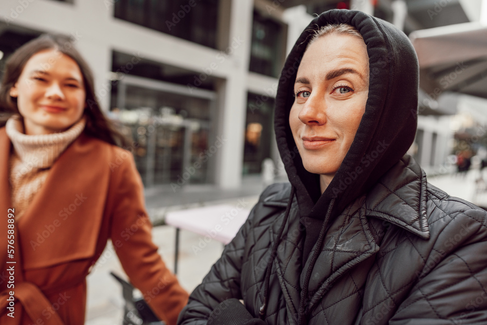Two women in autumn outside in the city Two women in autumn outside in the city