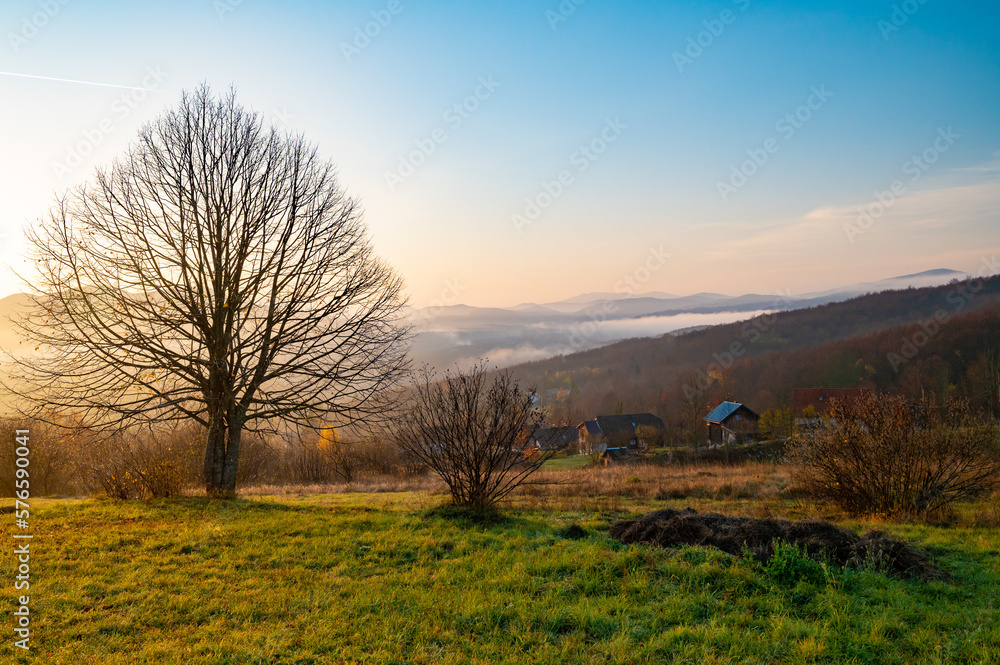 Fototapeta premium Plitvice Lakes National Park during colorful autumn, Croatia, Europe. Fall colors leafs on trees. Waterfalls and water in sunny morning light with fog. Landscape photography. View of Plitvicka Jezera.
