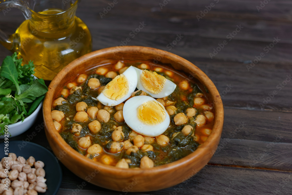 Fototapeta premium wooden bowl with chickpeas with spinach and hard-boiled egg