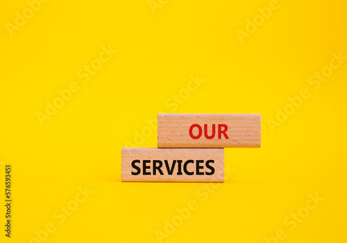Our services symbol. Concept words Our services on wooden blocks. Beautiful yellow background. Business and Our services concept. Copy space.